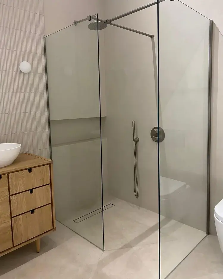Wide context shot of full microcement bathroom showing seamless wet-area finish — Hampton