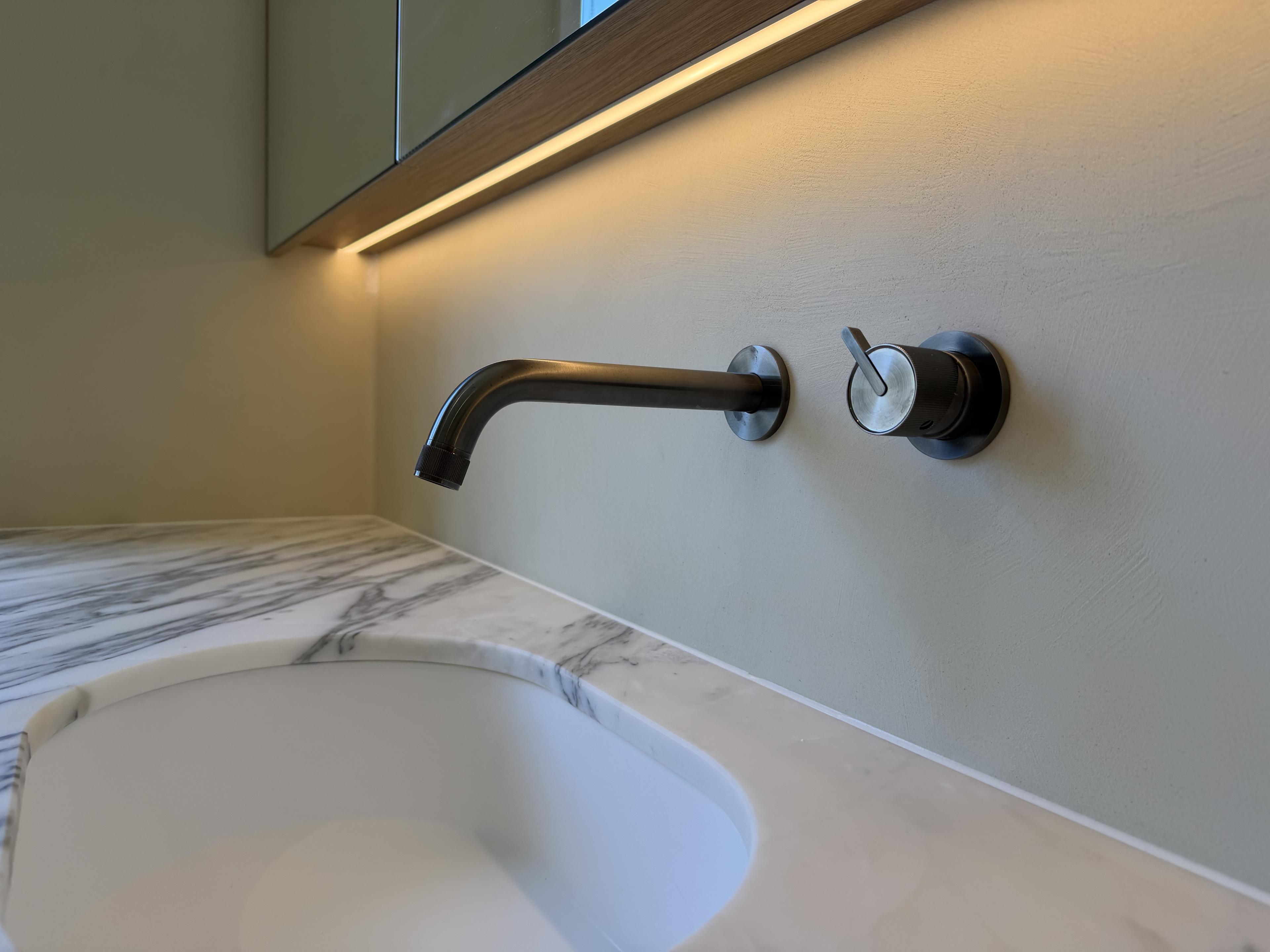 Close-up of Calacatta marble vanity with brushed gunmetal tapware — Malvern
