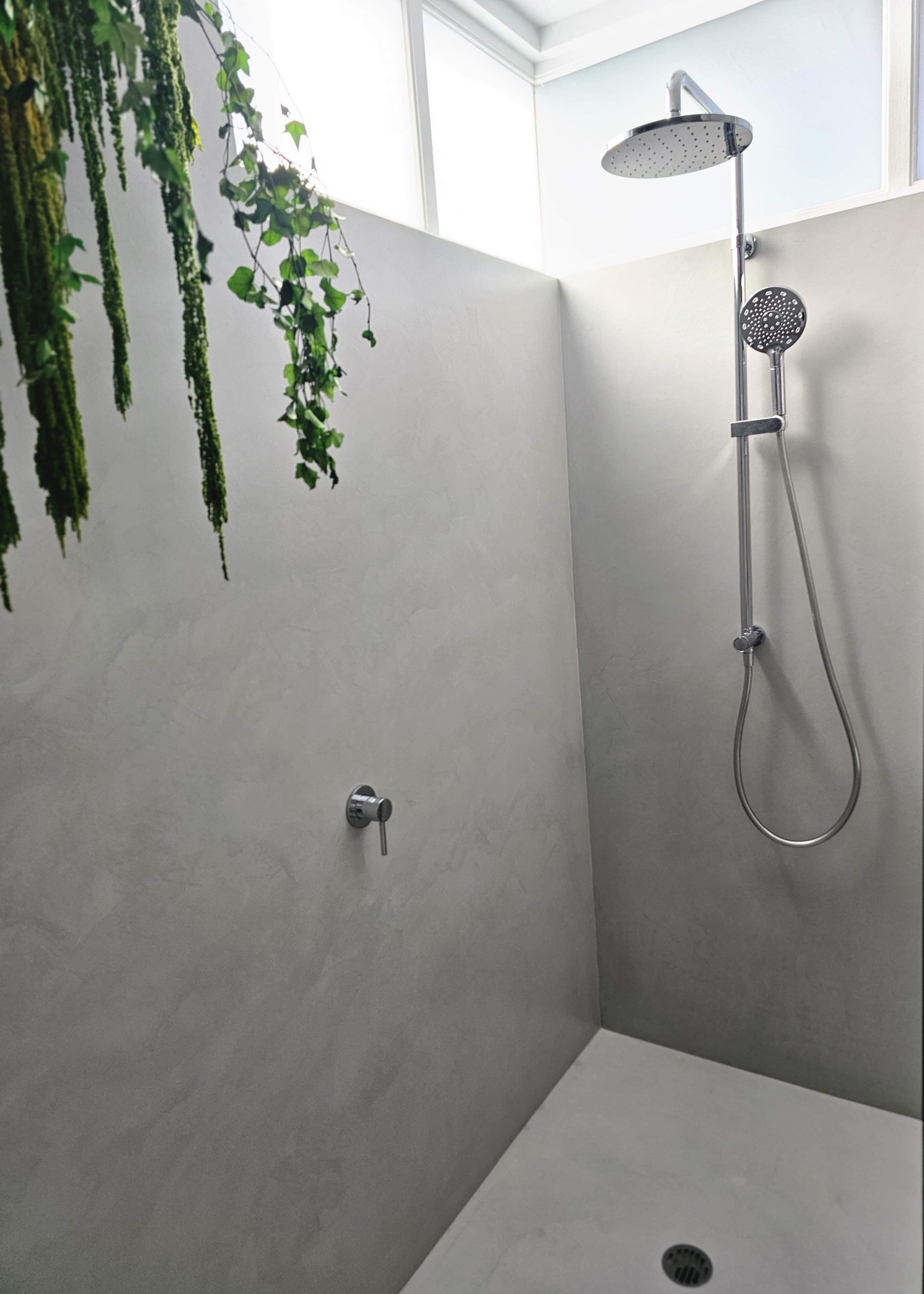 Shower with hanging greenery against grey microcement walls — Richmond